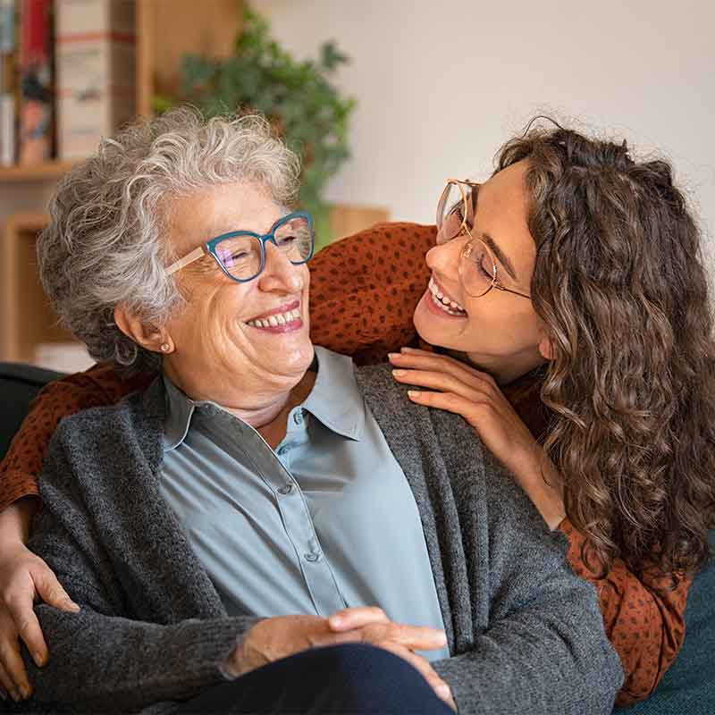 Grown daughter laughing with her mother. 